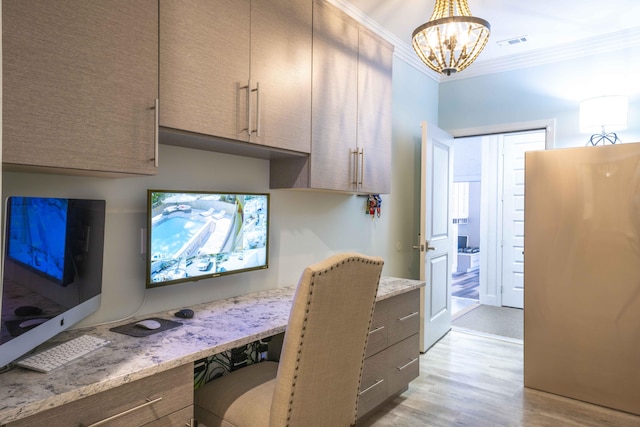 home office with a notable chandelier, visible vents, light wood-style flooring, ornamental molding, and built in study area