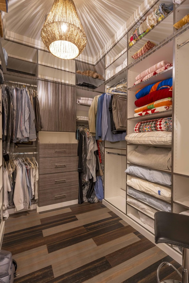 walk in closet featuring an inviting chandelier