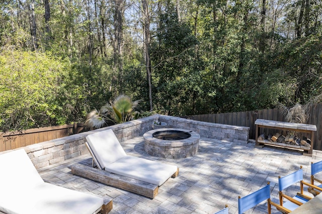 view of patio / terrace with a fenced backyard and a fire pit