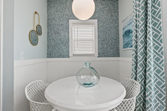 dining space featuring wainscoting