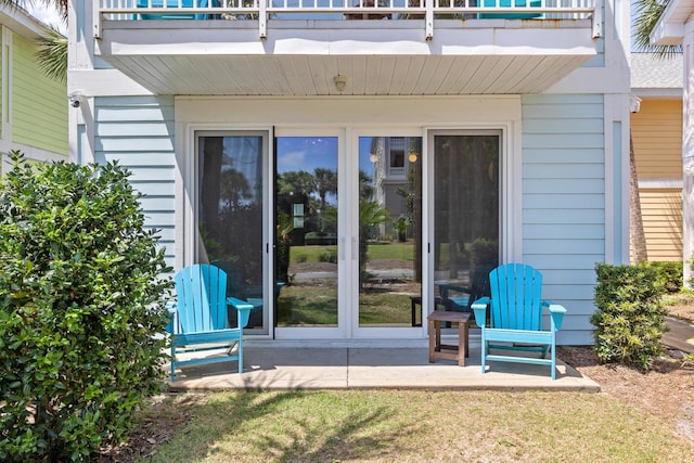 property entrance featuring a balcony and a patio area