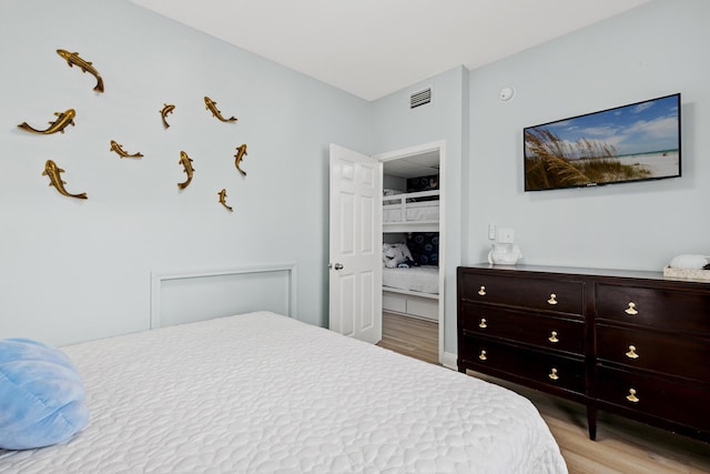 bedroom featuring visible vents and light wood-style floors