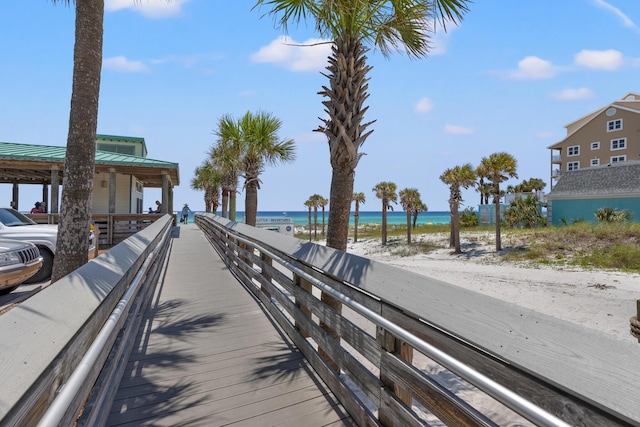 dock area featuring a view of the beach and a water view