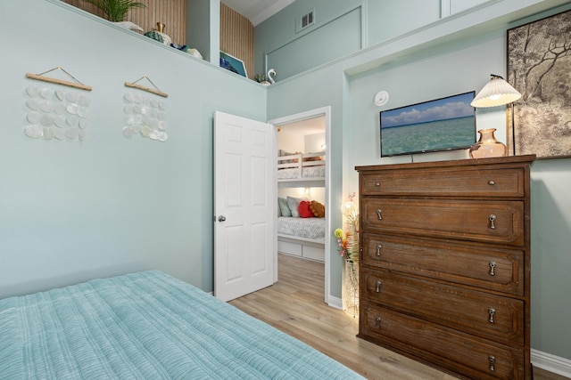 bedroom with visible vents and light wood-style flooring