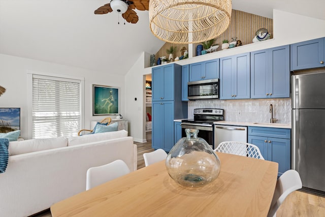 dining space featuring light wood-type flooring, high vaulted ceiling, and a ceiling fan