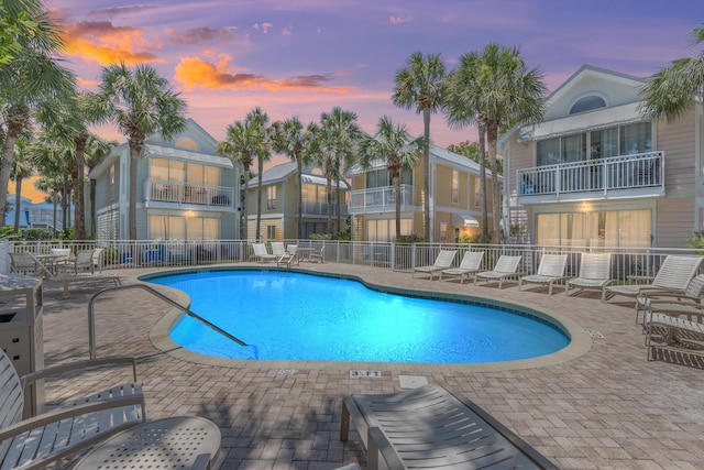 community pool featuring a patio area and fence