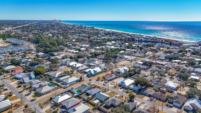 drone / aerial view featuring a water view and a view of the beach