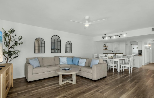 living room featuring dark hardwood / wood-style flooring and ceiling fan