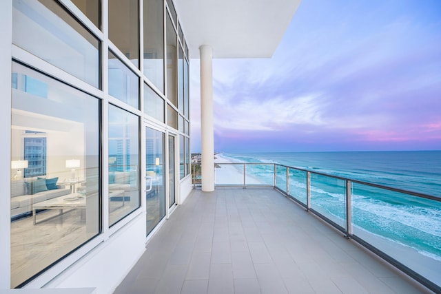 balcony with a water view and a beach view