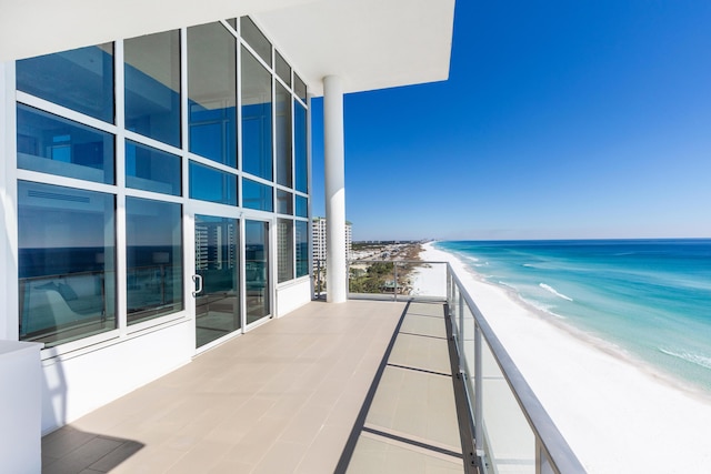 balcony with a beach view and a water view