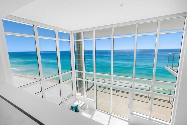 interior space featuring a water view and a view of the beach