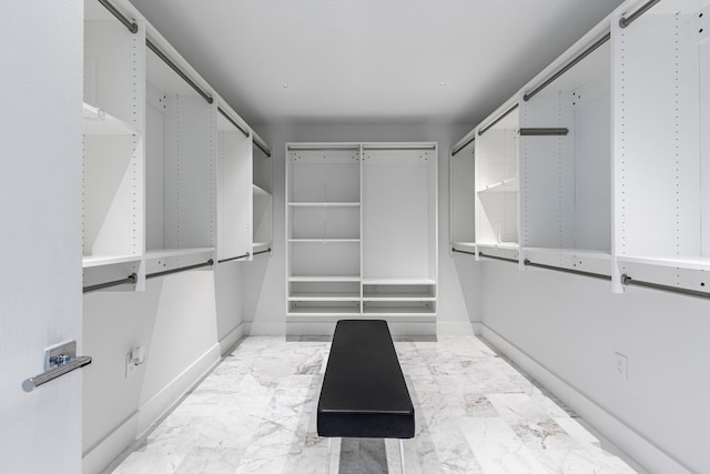 spacious closet with marble finish floor