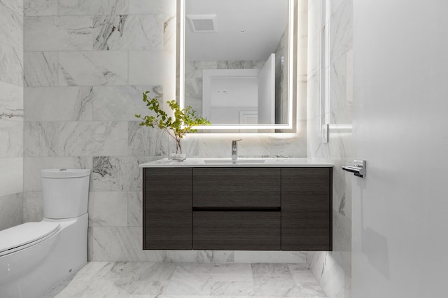 bathroom with visible vents, vanity, and toilet