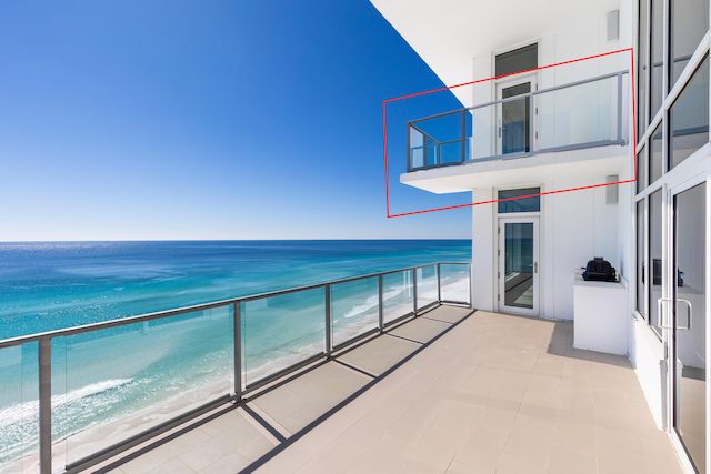 balcony with a water view and a beach view