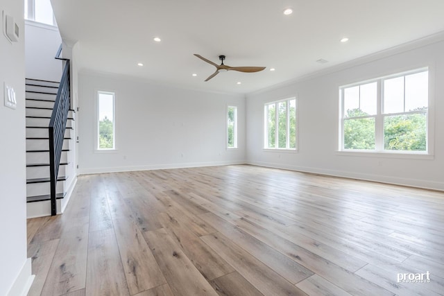 unfurnished living room with crown molding, ceiling fan, and light wood-type flooring