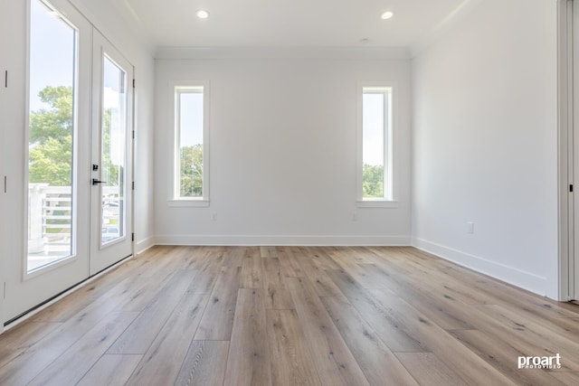 unfurnished room with crown molding and light wood-type flooring