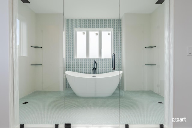 bathroom with independent shower and bath and tile patterned floors