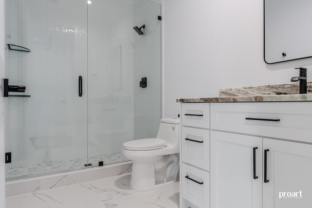 bathroom with vanity, walk in shower, and toilet