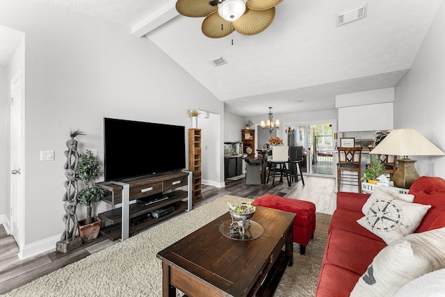 living room with hardwood / wood-style flooring, a notable chandelier, high vaulted ceiling, and beamed ceiling