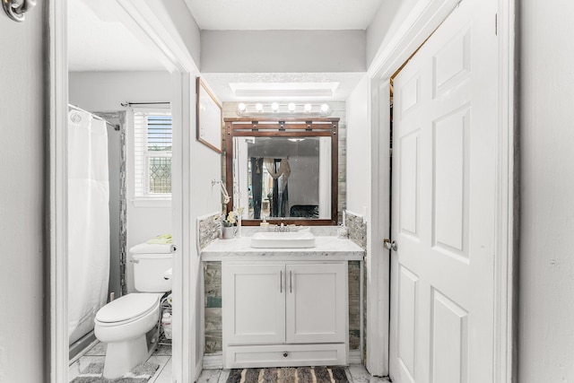 bathroom featuring vanity, walk in shower, and toilet