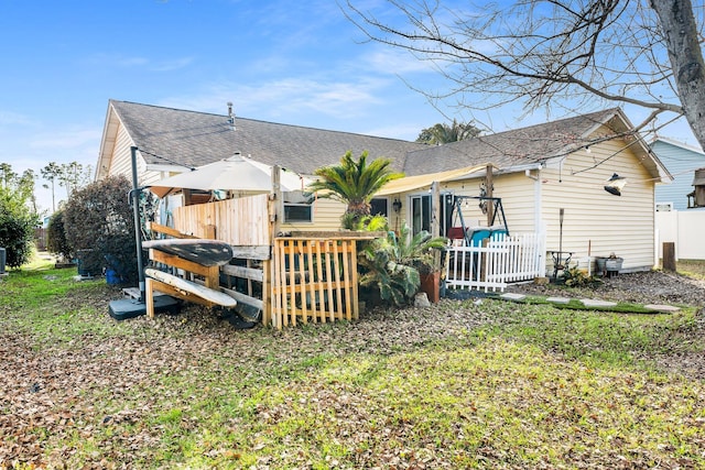 rear view of property with a lawn