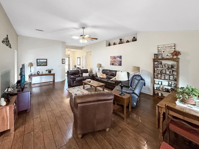 living room with lofted ceiling, dark wood-type flooring, and ceiling fan