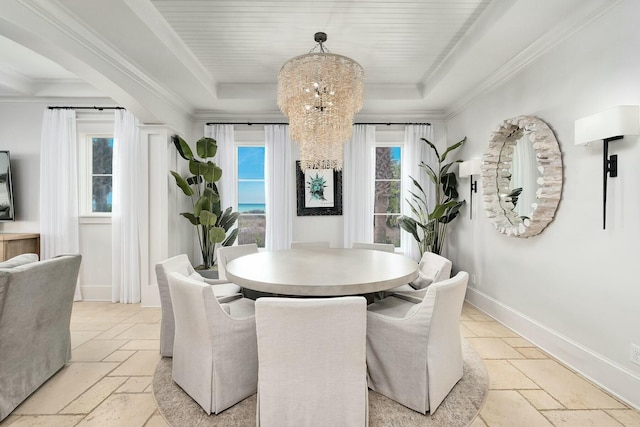 dining area featuring stone tile flooring, baseboards, crown molding, and a tray ceiling