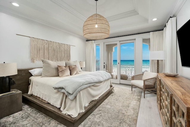 bedroom with crown molding, recessed lighting, wood finished floors, a raised ceiling, and access to outside