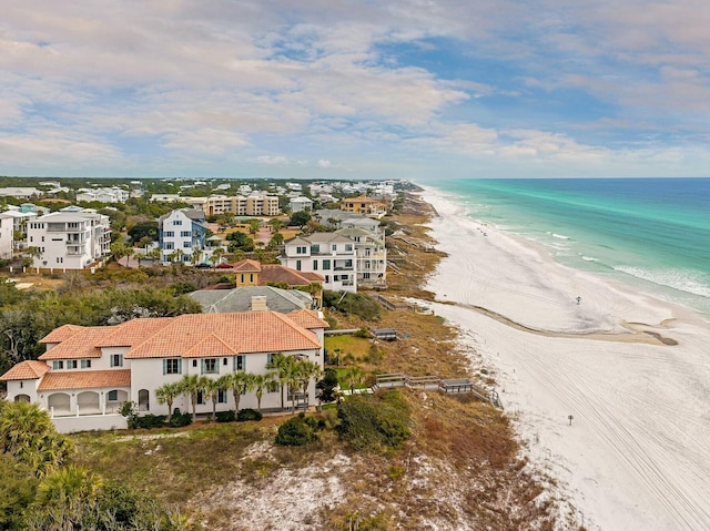 drone / aerial view featuring a beach view and a water view