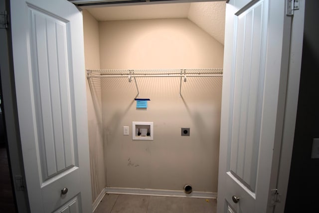 laundry room with hookup for an electric dryer, hookup for a washing machine, and light tile patterned floors