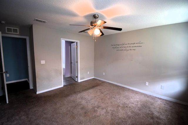 unfurnished bedroom featuring ceiling fan, dark carpet, and a textured ceiling