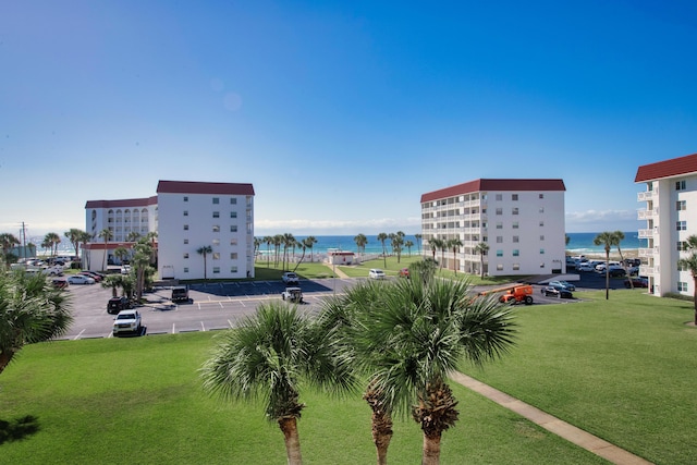 view of home's community featuring a water view, uncovered parking, and a yard