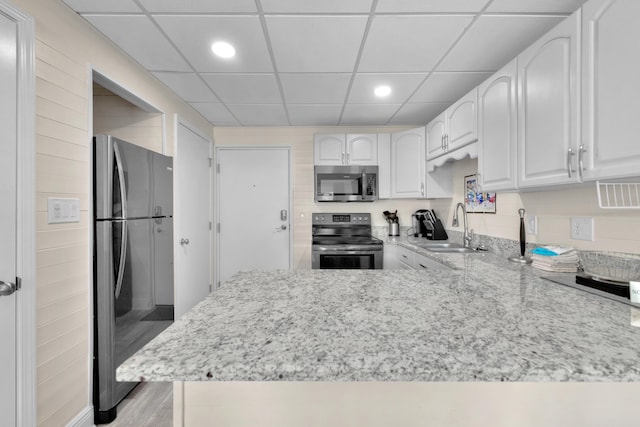 909 Santa Rosa Blvd Unit 611, Fort Walton Beach, FL 32548 - kitchen featuring stainless steel appliances, a peninsula, a sink, and white cabinets