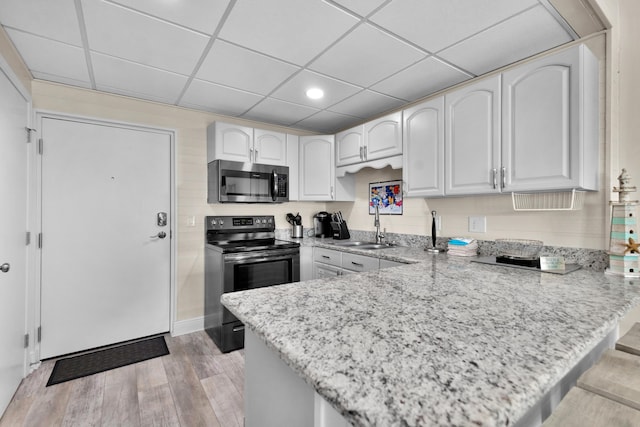 909 Santa Rosa Blvd Unit 611, Fort Walton Beach, FL 32548 - kitchen with a peninsula, white cabinetry, and stainless steel appliances