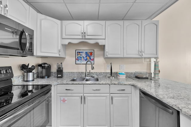 909 Santa Rosa Blvd Unit 611, Fort Walton Beach, FL 32548 - kitchen featuring a drop ceiling, white cabinetry, stainless steel appliances, and a sink