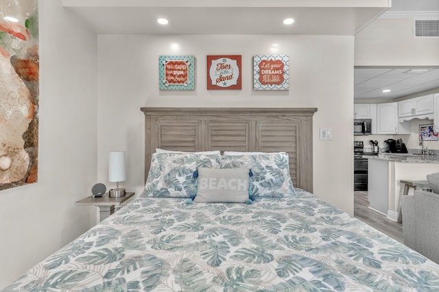 909 Santa Rosa Blvd Unit 611, Fort Walton Beach, FL 32548 - bedroom featuring a sink, visible vents, wood finished floors, and recessed lighting