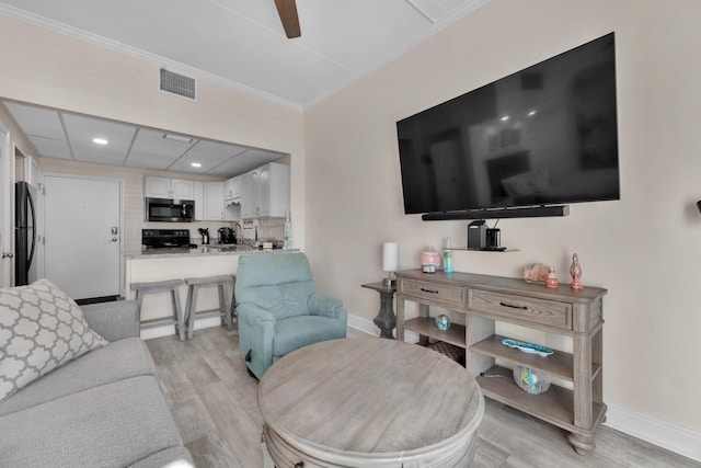 909 Santa Rosa Blvd Unit 611, Fort Walton Beach, FL 32548 - living area featuring light wood finished floors, baseboards, visible vents, and ornamental molding