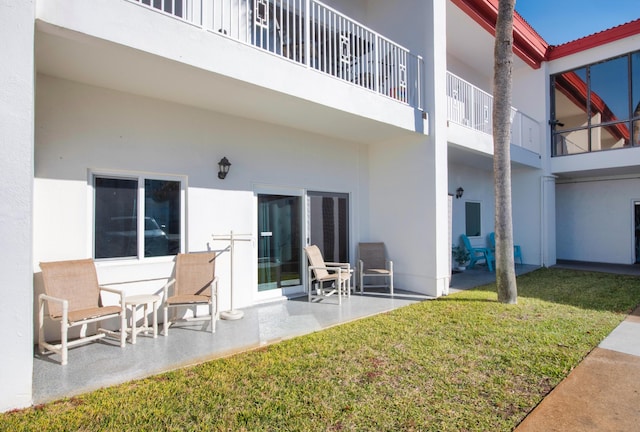 909 Santa Rosa Blvd Unit 611, Fort Walton Beach, FL 32548 - back of house featuring a patio, a yard, a balcony, and stucco siding