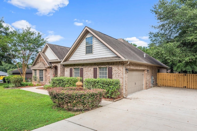 view of front of home featuring a garage and a front lawn