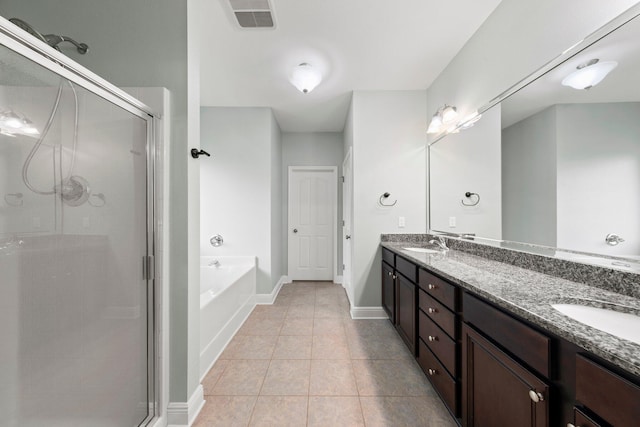 bathroom with tile patterned flooring, vanity, and plus walk in shower