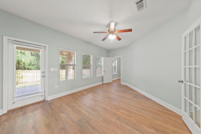 unfurnished room with ceiling fan, plenty of natural light, and light wood-type flooring