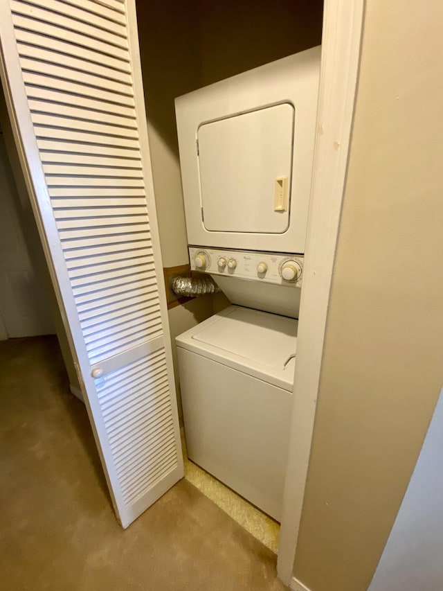 clothes washing area featuring laundry area and stacked washer / dryer