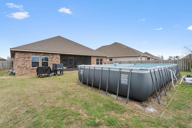view of pool featuring a fenced in pool, fence, and a lawn