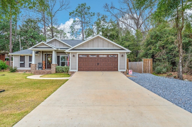 view of front facade featuring a garage, a front yard, and covered porch