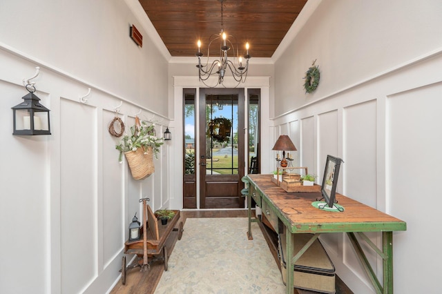 entrance foyer featuring hardwood / wood-style flooring, ornamental molding, wooden ceiling, and a chandelier