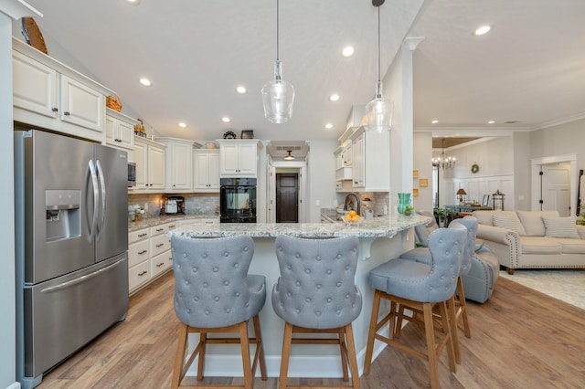 kitchen featuring stainless steel refrigerator with ice dispenser, a breakfast bar area, light stone counters, kitchen peninsula, and pendant lighting