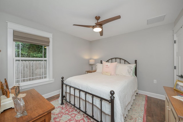 bedroom with dark wood-type flooring and ceiling fan