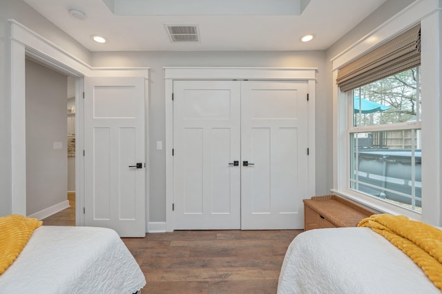 bedroom featuring dark wood-type flooring and a closet