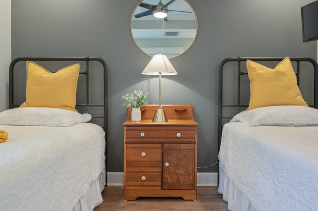 bedroom with dark wood-type flooring