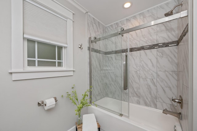 bathroom with bath / shower combo with glass door